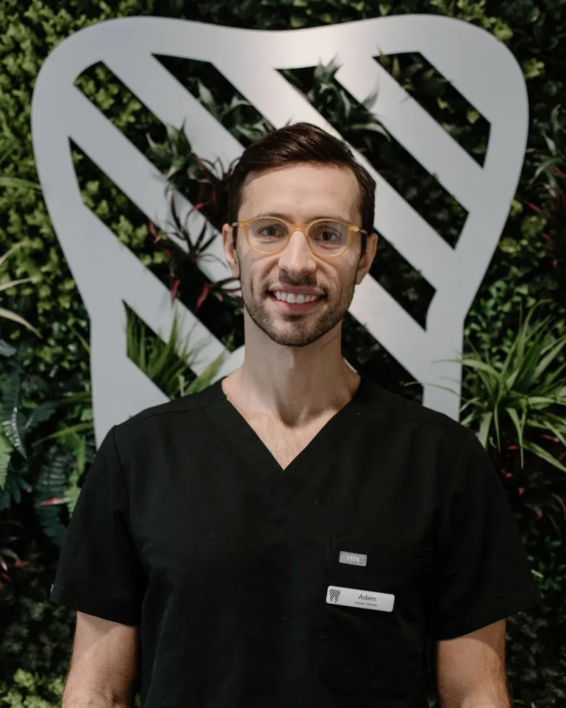 Portrait of Dr Adam Bzeu, implant dentist at Dentistry by Cure Clinics